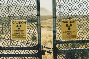 Nuclear waste signs on fence urging caution