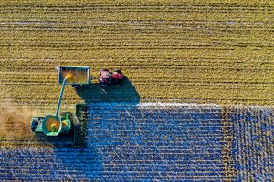 Birds eye view of farm - visible tractor and crops in field