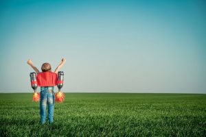 Child with jet pack reaching for the sky - Smart Grants innovation concept